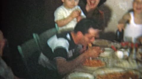 1951: Big Family at Crowded Dinner Table Eat Italian Food.