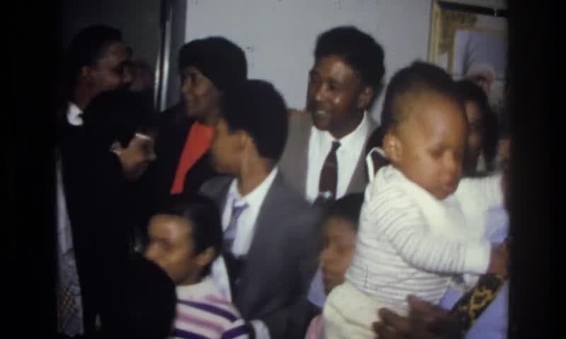 1976: Harlem, New York, USA. A Group Of People Standing At Formal Family Event.