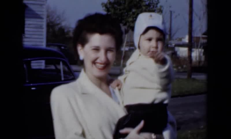 1950: New York. A Woman Holding A Baby In Her Arms.