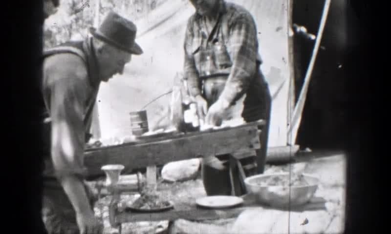 1939: Chelan, Washington. A Couple Of Men Standing Working In A Camp