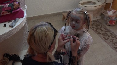 Mother Applying Make-up to her Daughter