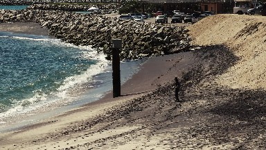 Man Preparing to Fish in Blue Ocean