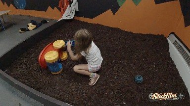 Toddler playing in an indoor sandbox. Denver, Colorado USA
