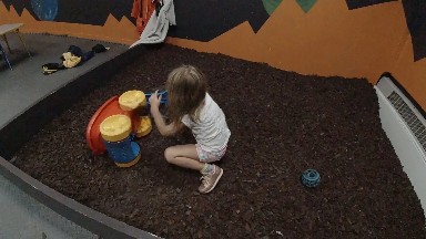 Toddler playing in an indoor sandbox. Denver, Colorado USA