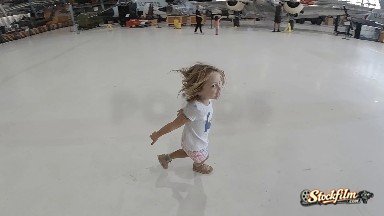Toddler Girl Running Inside Building With White Floor. Denver, Colorado.