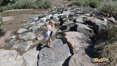 Toddler Climbing Rocks in Urban Stream. Denver, Colorado