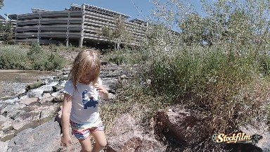 Denver, United States: Little Girl Climbing Rocks in the City. Denver, Colorado