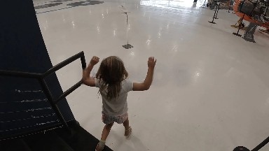 Young Girl Running Down Stairs. Denver, Colorado