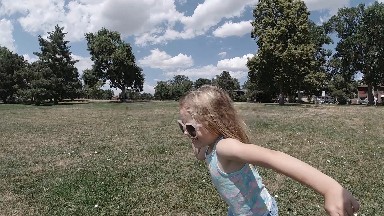 Little Girl That Is Standing In The Grass
