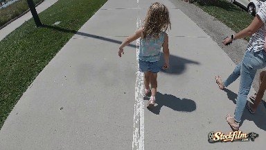 Child Walking down busy Sidewalk. Denver, Colorado.