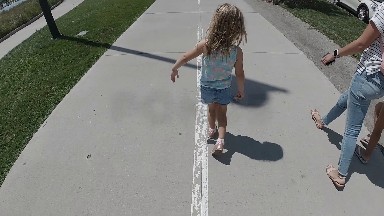 Child Walking down busy Sidewalk. Denver, Colorado.