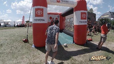 Man Kicking Soccer Ball into Inflatable Goal. Denver, Colorado.