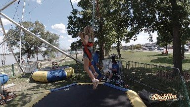 Child bouncing on inflatable at festival. Denver, Colorado