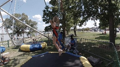 Child bouncing on inflatable at festival. Denver, Colorado