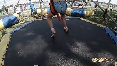 Child Jumping on Inflatable Bounce Pad. Denver, Colorado.