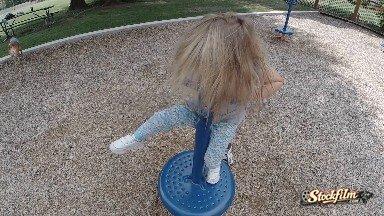 Young Girl Spinning At The Playground. Denver, Colorado