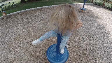 Young Girl Spinning At The Playground. Denver, Colorado