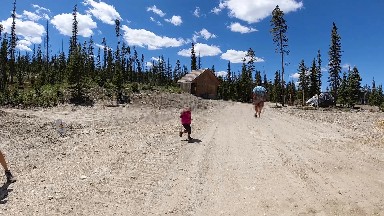 People Walking On A Dirt Road With A Little Girl