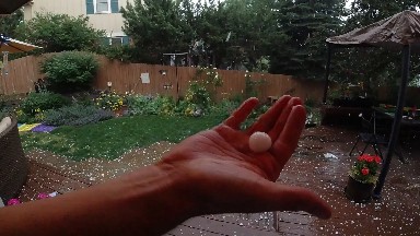 Someone Is Holding Their Hand Out In The Rain Outside