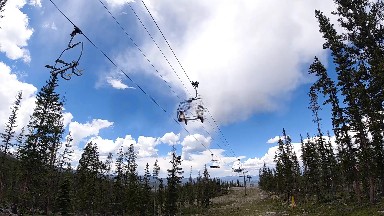Many People Riding A Ski Lift In The Mountains