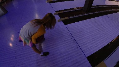 Woman Standing On A Purple Floor In A Building