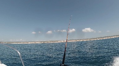 Fishing On A Boat In The Ocean With A Rod