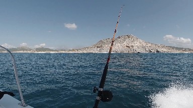 Fishing Rod On A Boat With A Mountain In The Background