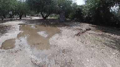 Puddle Of Water On The Ground In The Middle Of The Road