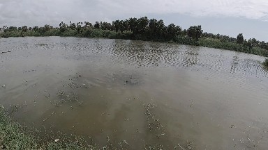 Large Body Of Water With A Small Boat In It