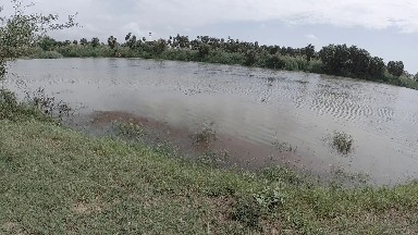 Large Body Of Water That Is In The Middle Of A Field