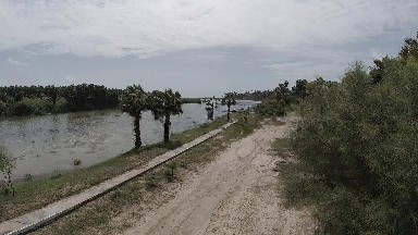 Dirt Road That Is Next To A Body Of Water