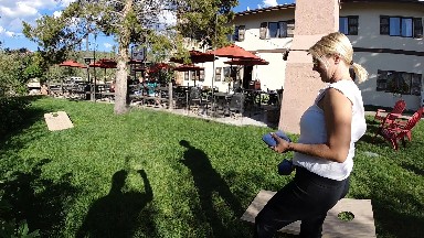 Woman Standing In The Grass With A Cell Phone