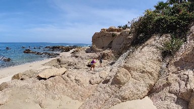 People Walking On The Rocks Near The Water