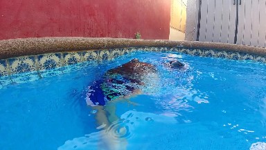 Man Swimming In A Pool With A Frisbee