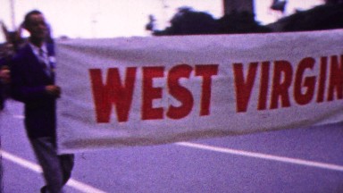 Indiana, USA. 1963: Marching Band in Parade with West Virginia State Banner