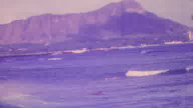 Honolulu Hawaii USA (1964): People Swimming In An Ocean Near A Mountain