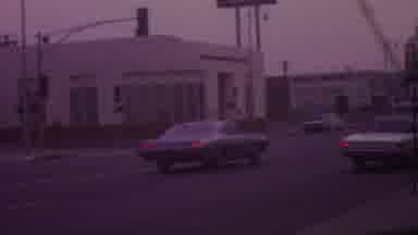Los Angeles USA (1965): Cars Stopping At A Red Light While Pedestrian Is Crossing