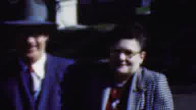 Wisconsin USA-1954: Three Well-Dressed People Watch A Famous Person Arrive From