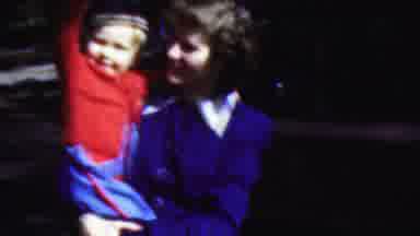 Wisconsin USA (1954): Young Lady Holding A Toddler Whos Waving At Family With