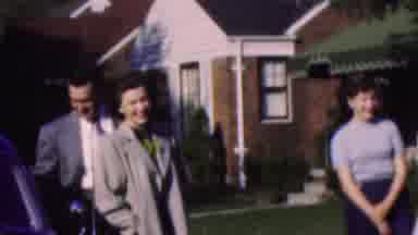 Wisconsin USA (1954): Four Adults Laughing Next To A Car And A Toddler Sat On A