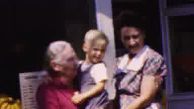 Wisconsin USA (1954): People Holding Boy In Front Of Window