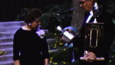 California USA (1961): An Older Man Is Giving An Older Woman A Trophy For A