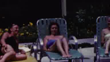 California USA (1961): Women Sunbathing By The Pool