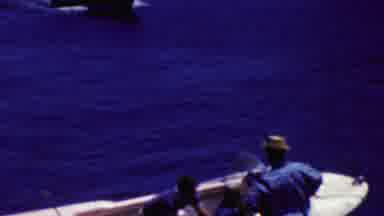 California USA (1961): Small Motor Boat Maneuvering Through Ships