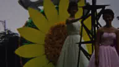 CALIFORNIA USA-1961: Two Women On A Sunflower Float With A Marching Band In A