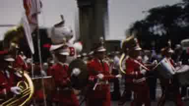 California USA (1961): Large Marching Band In A Parade With A Float To Match In