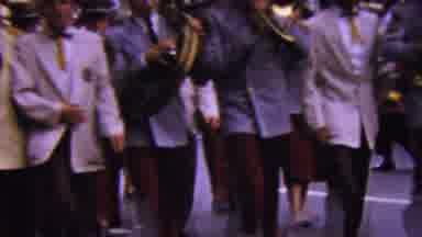 California USA (1961): Men Part Of A Marching Band Marching In Front Of A Parade