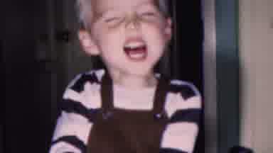 This blonde boy's so excited for Christmas, his smile's outgrowing his suspenders
