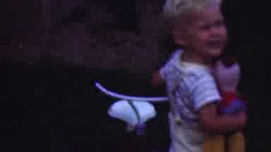 Cleveland Ohio USA (1953): A Blonde Boy Is Holding A Toy And Playing Next To His