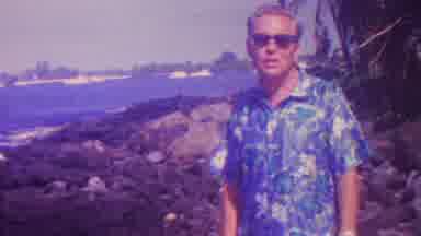 Hawaii USA (1962): Man In Floral Shirt Standing Next To Ocean With Light House In